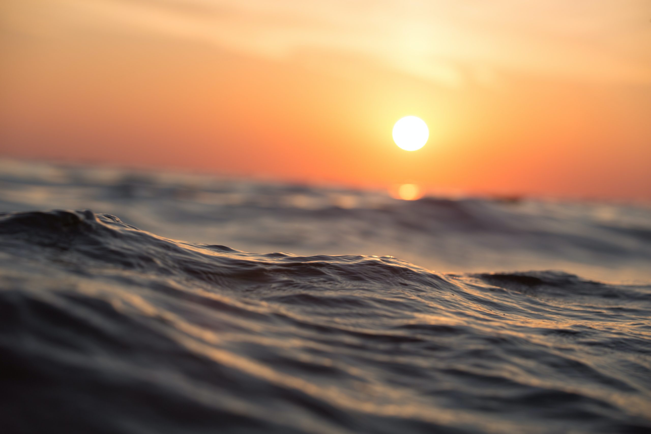 wavy ocean at sunset closeup of water blurred background